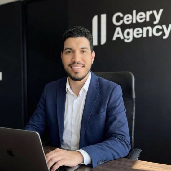 Rafael Azuaje at his desk, in front of the Celery Agency wall
